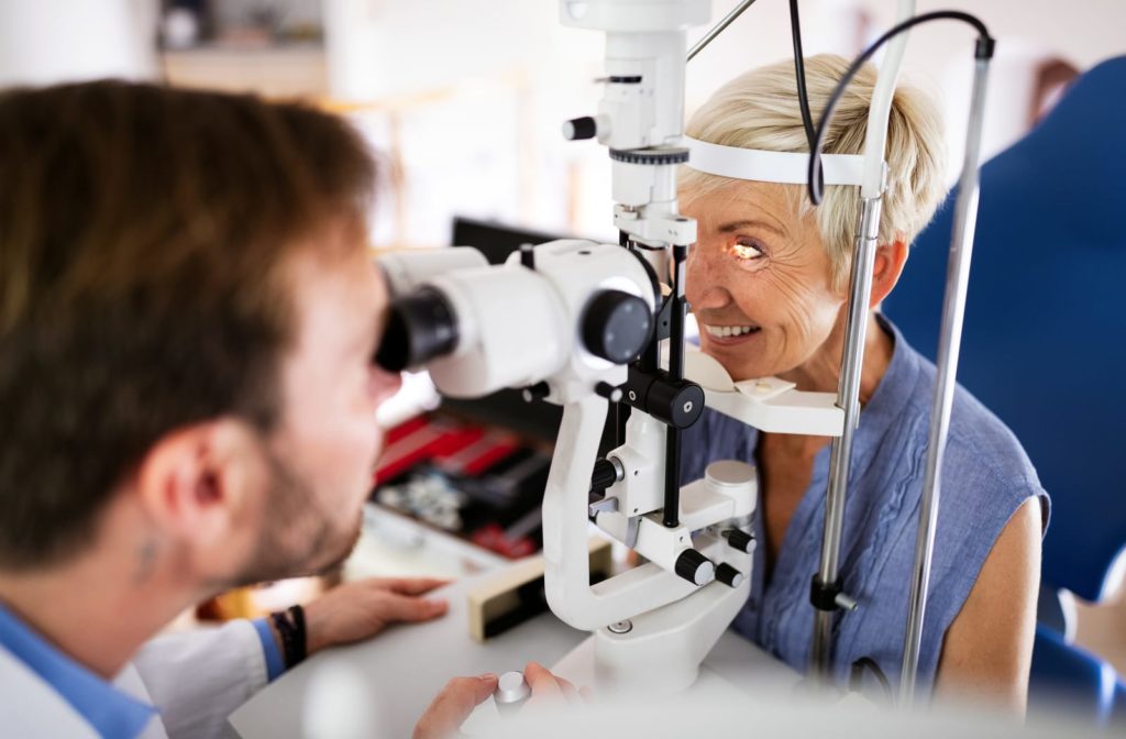 Smiling senior woman having diagnostic testing during her eye exam.