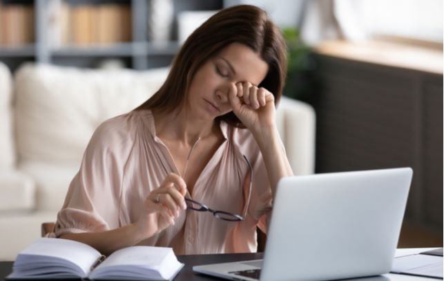 Women experiencing digital eye strain due to working on laptop for too long