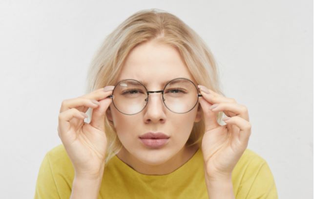Women squinting to correct vision due to her myopia condition