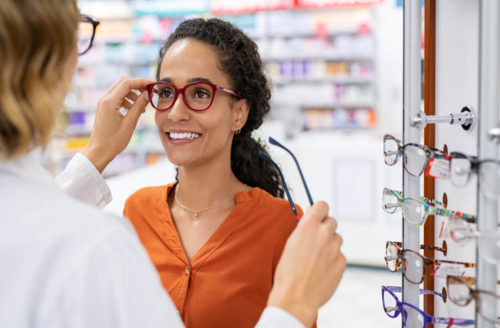 a woman visits her optometrist to have glasses fitted