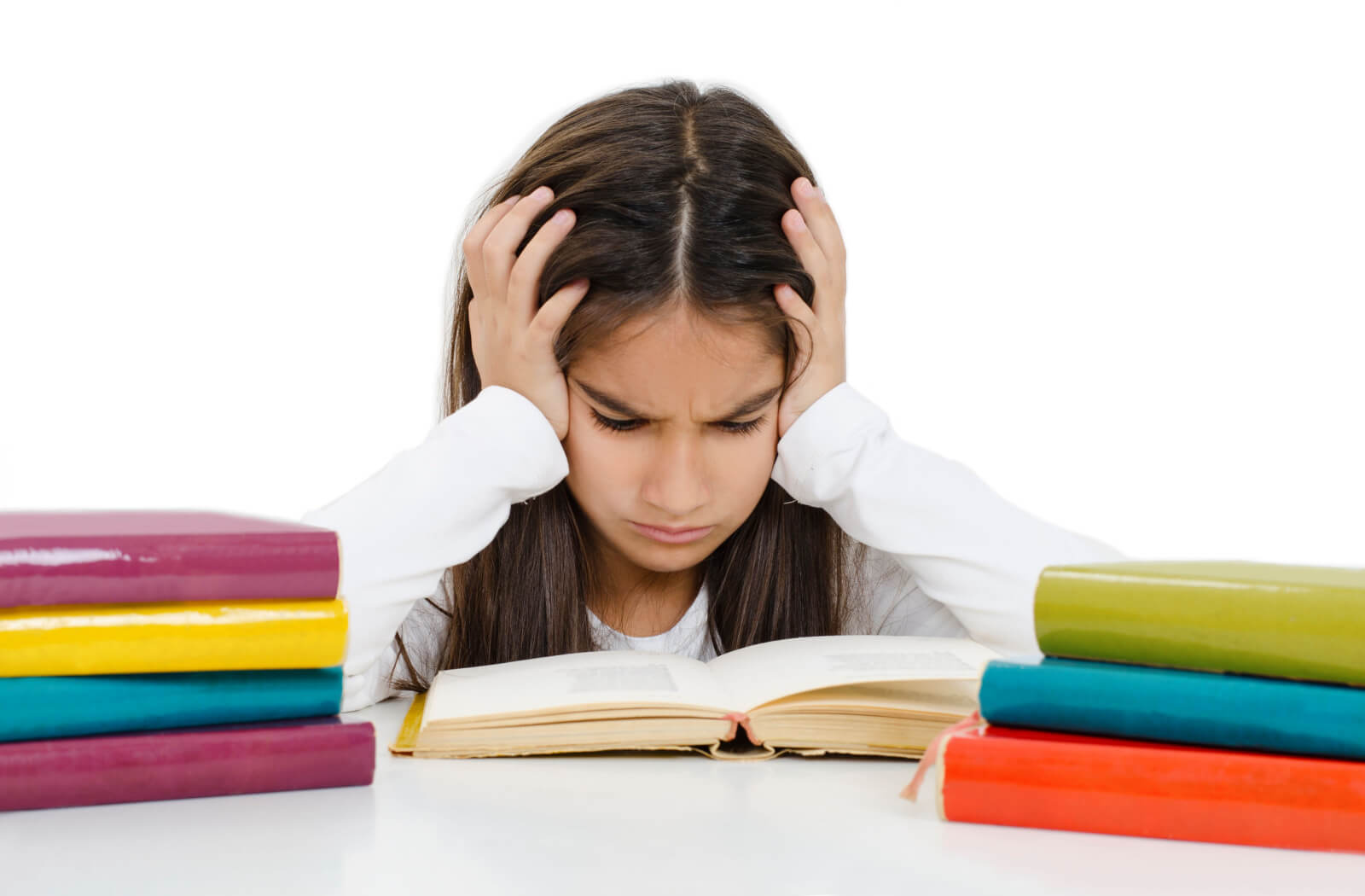 A young girl looking frustrated while reading with her hands on her head