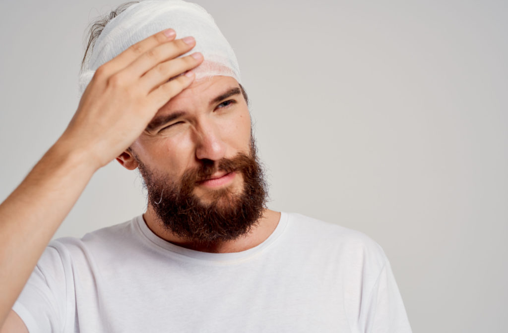 A man with a concussion with a bandage on his head.