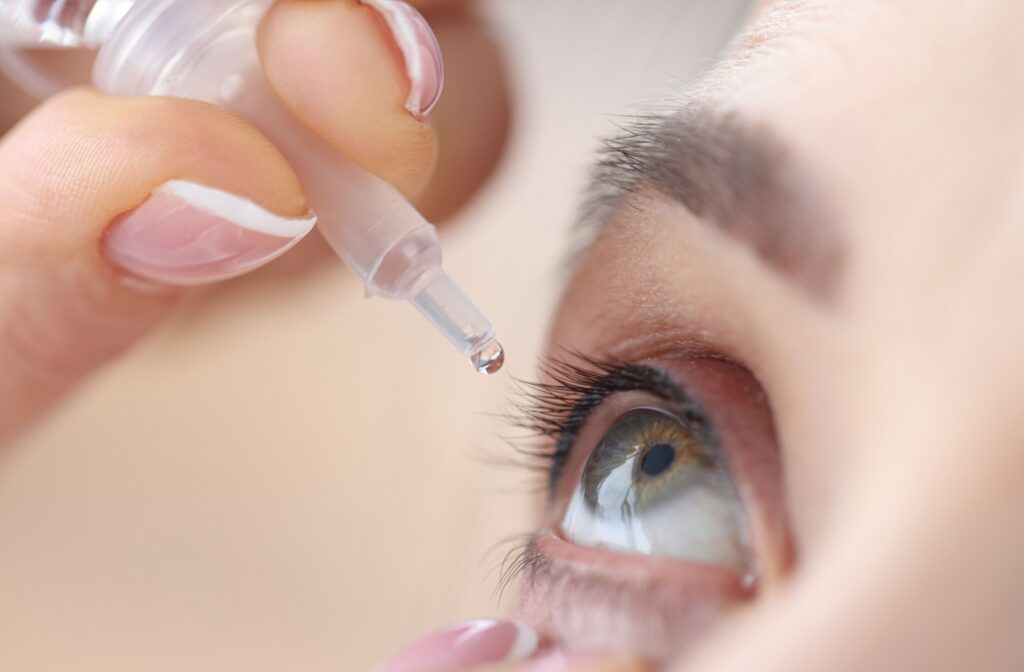 A close up of a woman's eye as she applies lubricating eye drops for dry eye.