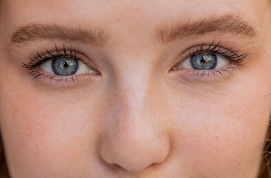 A close up photo of a person with blue eyes.