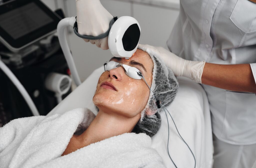 A patient wearing protective goggles and cooling gel undergoes an IPL session for their dry eye.